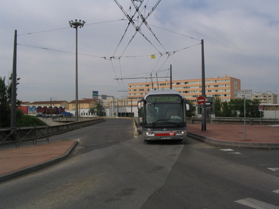 Trolejbus pøijíždí do terminálu L. Bonnevay jakoby v protismìru - ve skuteènosti se však jedná o preferenèní opatøení - tento pruh je jen pro MHD a jízdou vlevo se tak autobusy a trolejbusy vyhýbají dvojitému pøejíždìní protismìrù pøi levém odboèení na køižovatkách.